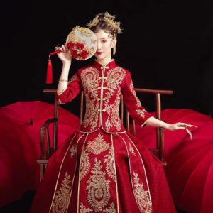 Girl wearing a Chinese wedding dress, red with golden embroidery