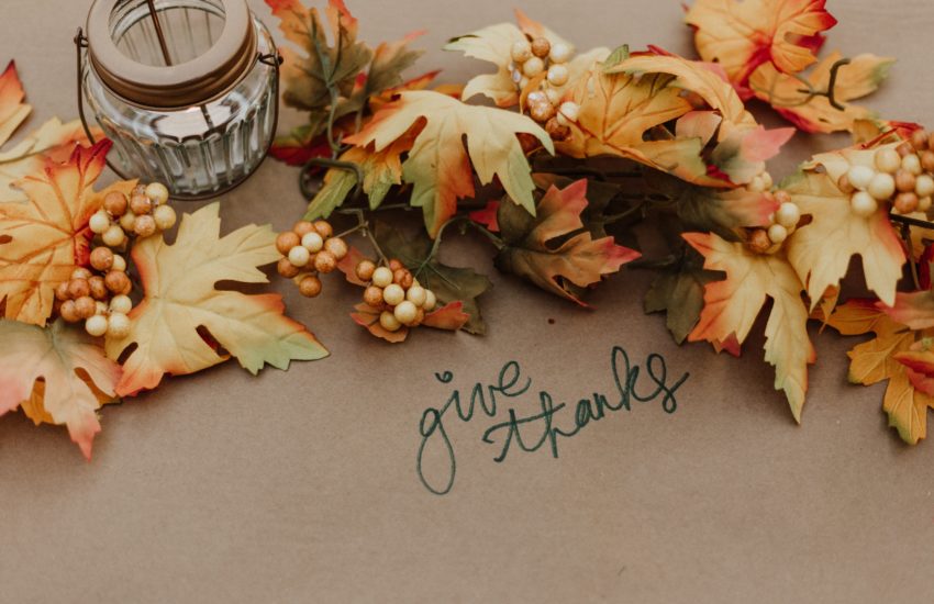 Autumnal leaves and the words give thanks for thanksgiving